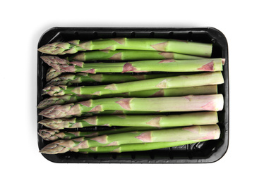 Fresh raw asparagus in plastic container isolated on white, top view