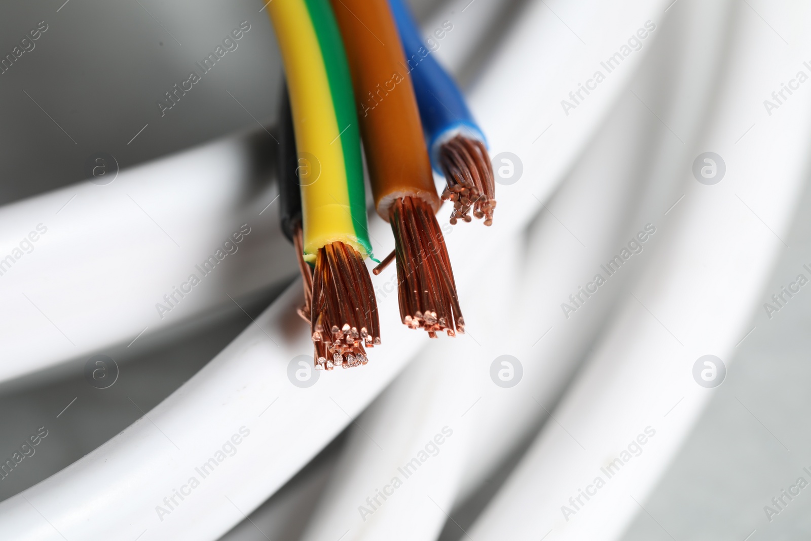 Photo of Colorful electrical wires on blurred background, closeup