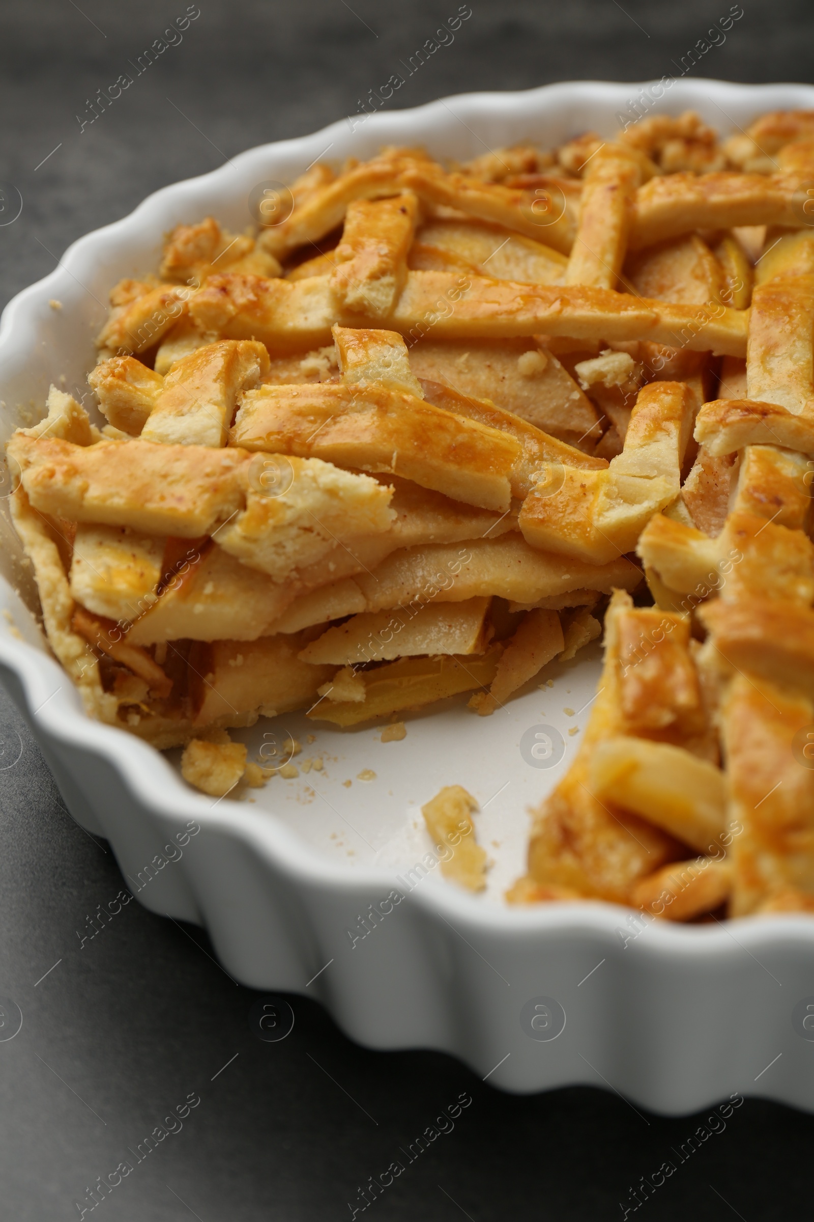 Photo of Tasty homemade quince pie on grey table, closeup