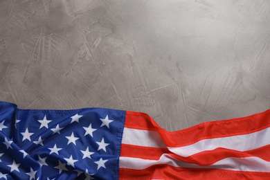 Photo of American flag on grey background, top view with space for text