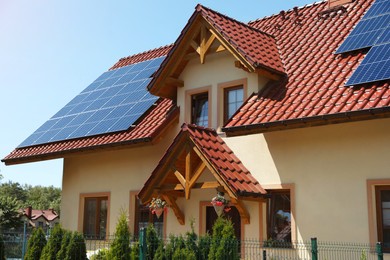 Photo of Exterior of beautiful house with solar panels on roof
