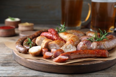 Photo of Set of different tasty snacks on wooden table, closeup view