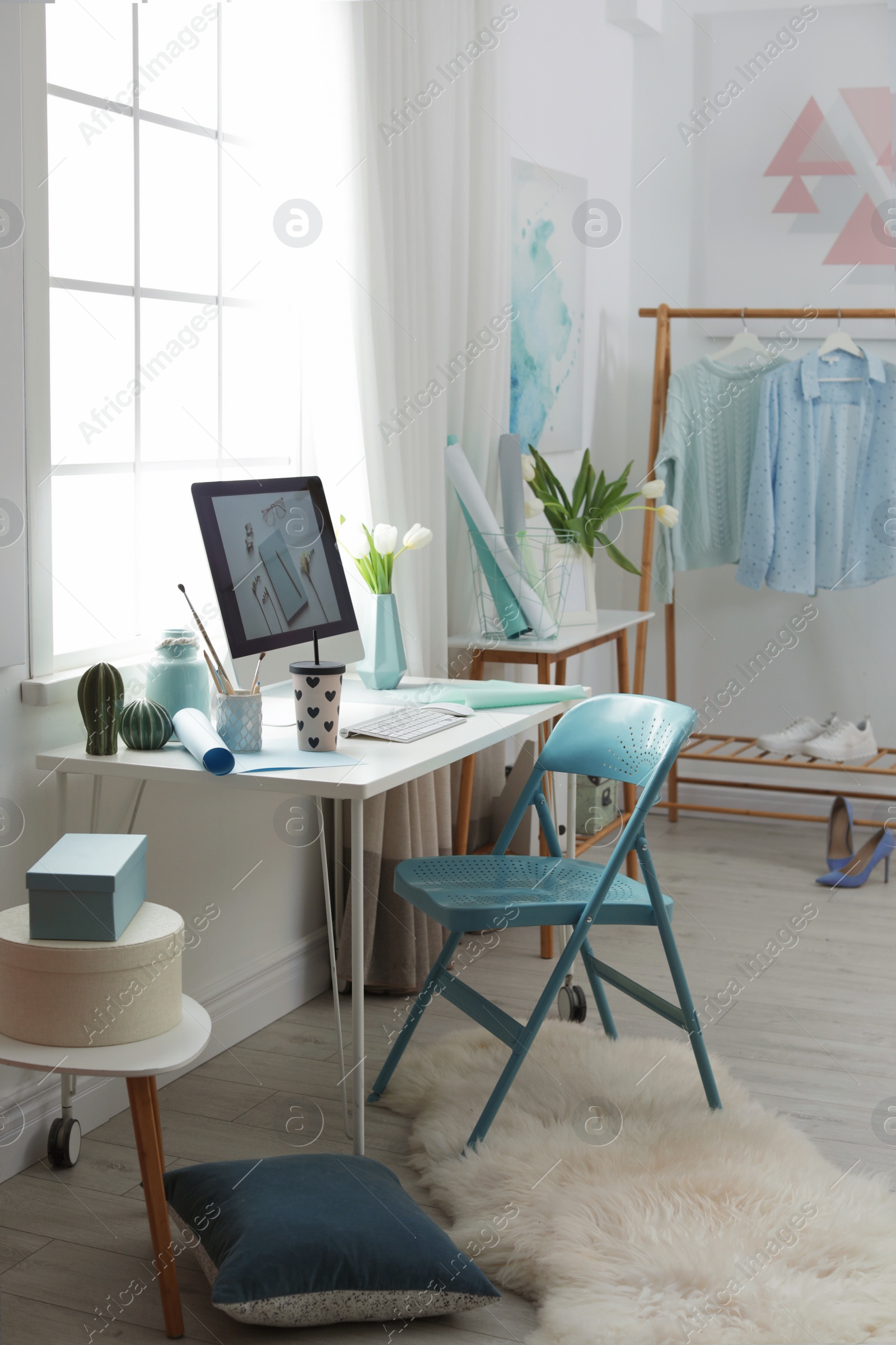 Photo of Stylish workplace interior with modern computer on desk