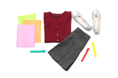 Photo of Stylish school uniform and stationery on white background, top view