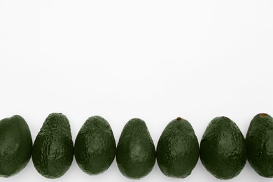 Photo of Tasty ripe avocados on white background, flat lay. Space for text