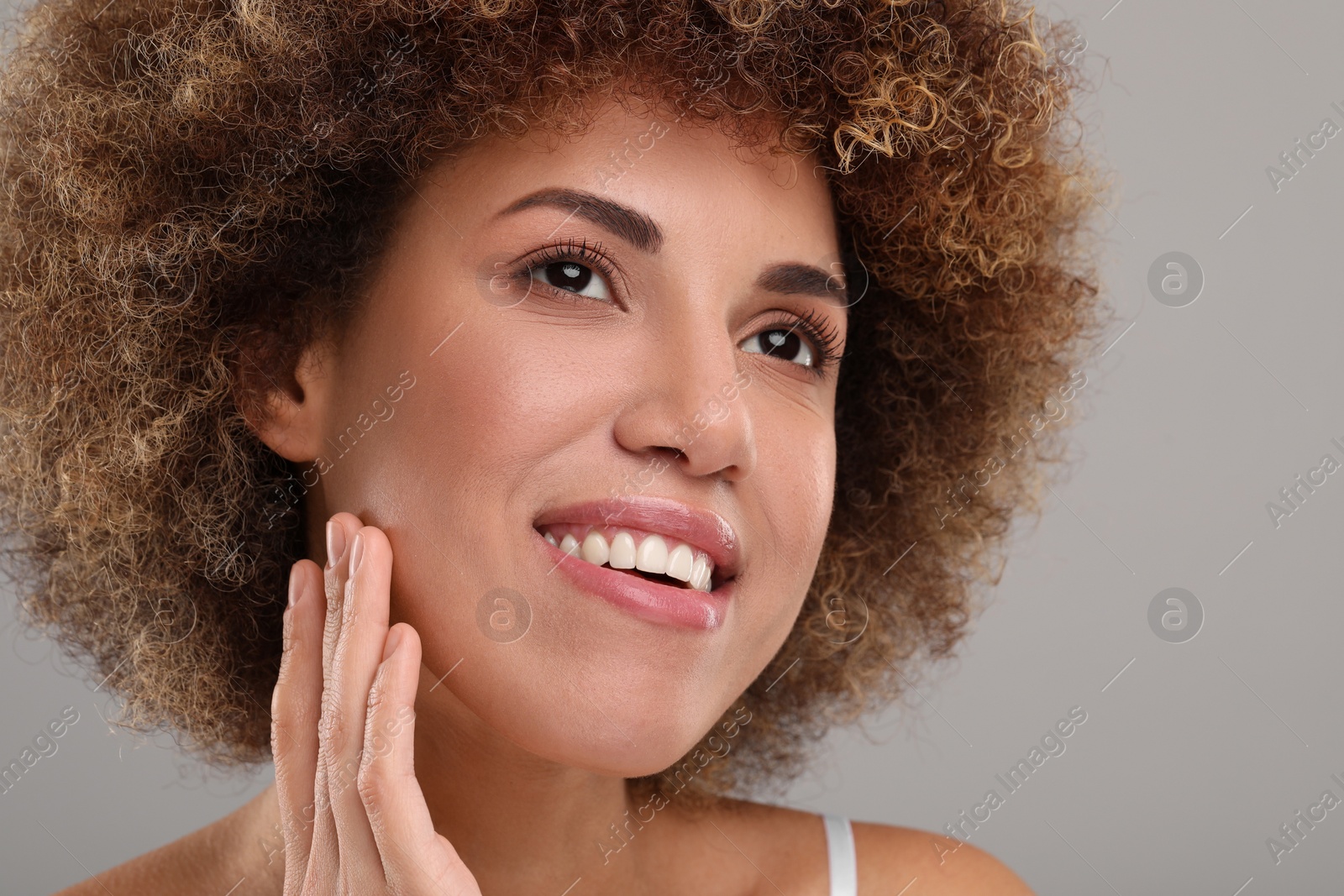 Photo of Beautiful woman with healthy skin on gray background