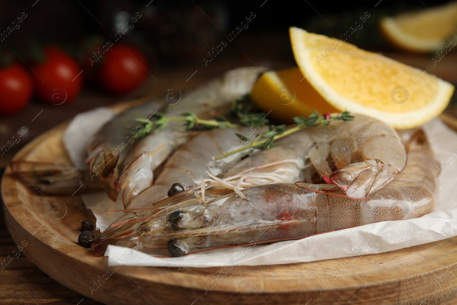 Photo of Fresh raw shrimps on wooden table, closeup