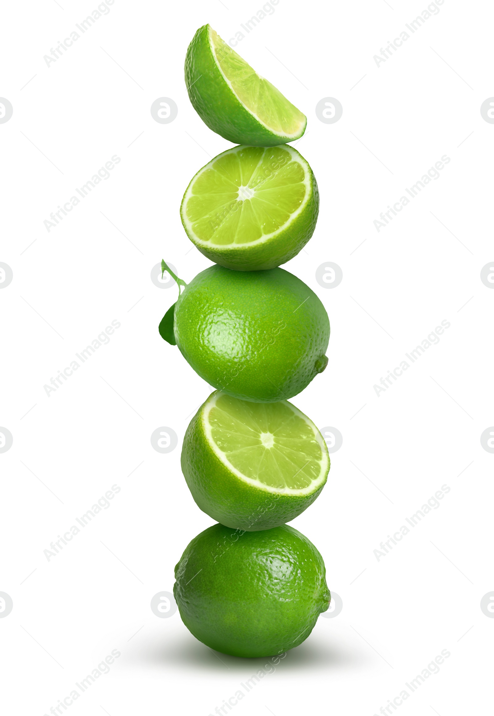 Image of Many stacked whole and cut limes on white background