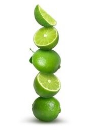 Image of Many stacked whole and cut limes on white background