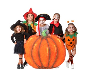 Photo of Cute little kids with decorative pumpkin wearing Halloween costumes on white background