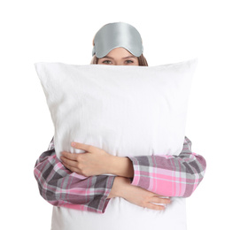 Young woman with pillow and sleep mask on white background