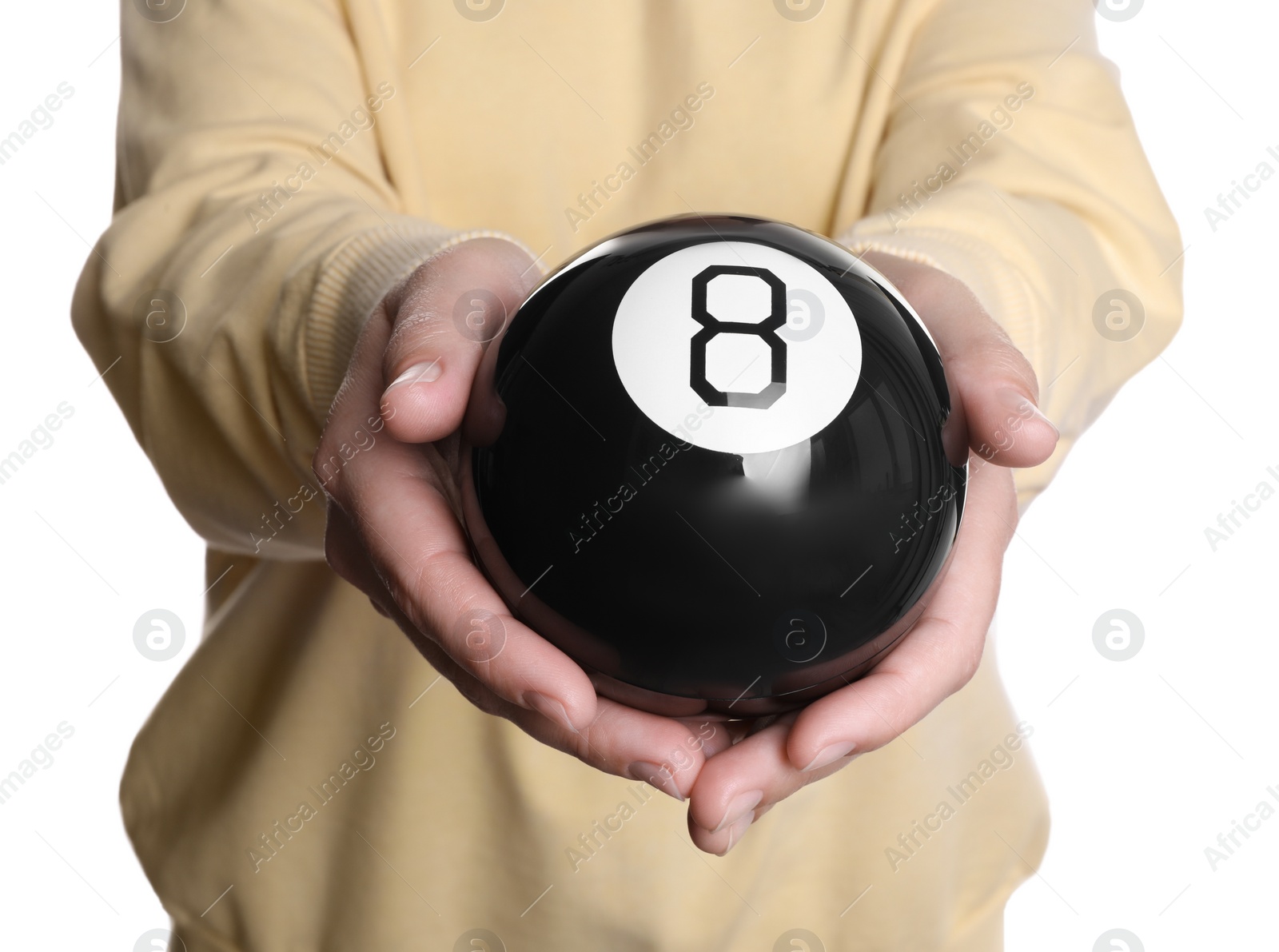 Photo of Woman holding magic eight ball on white background, closeup