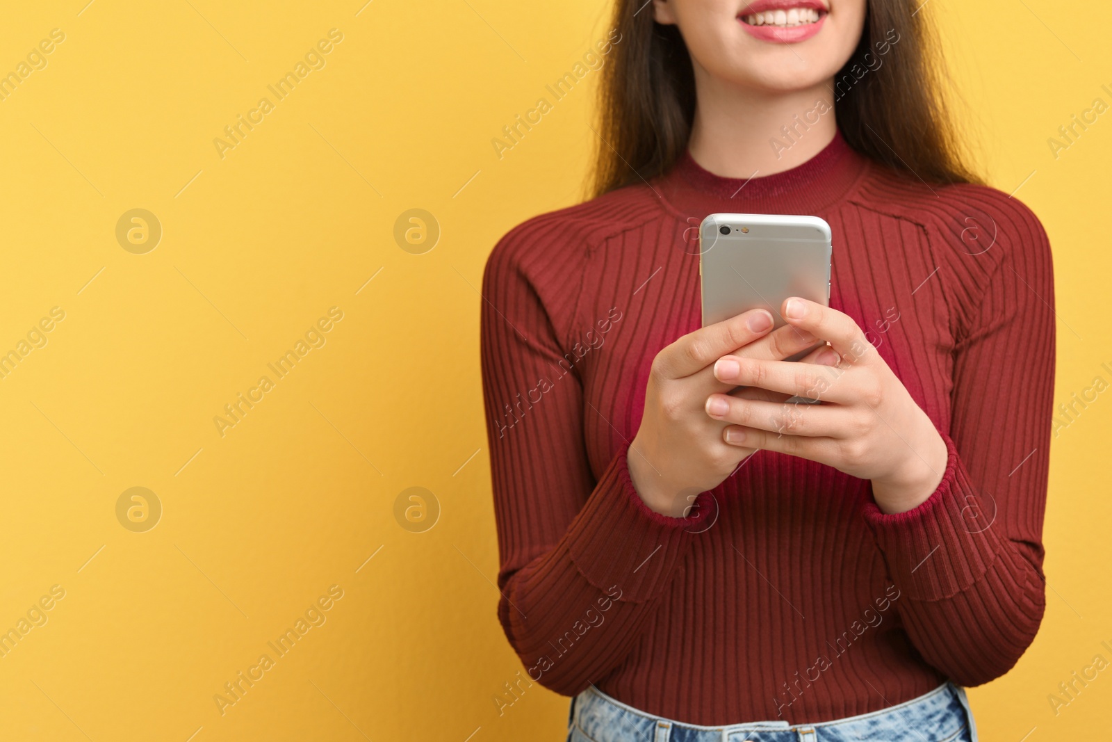 Photo of Young woman using phone on color background