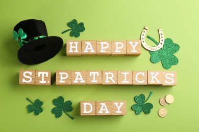 Photo of Words Happy St. Patrick's day and festive decor on green background, flat lay