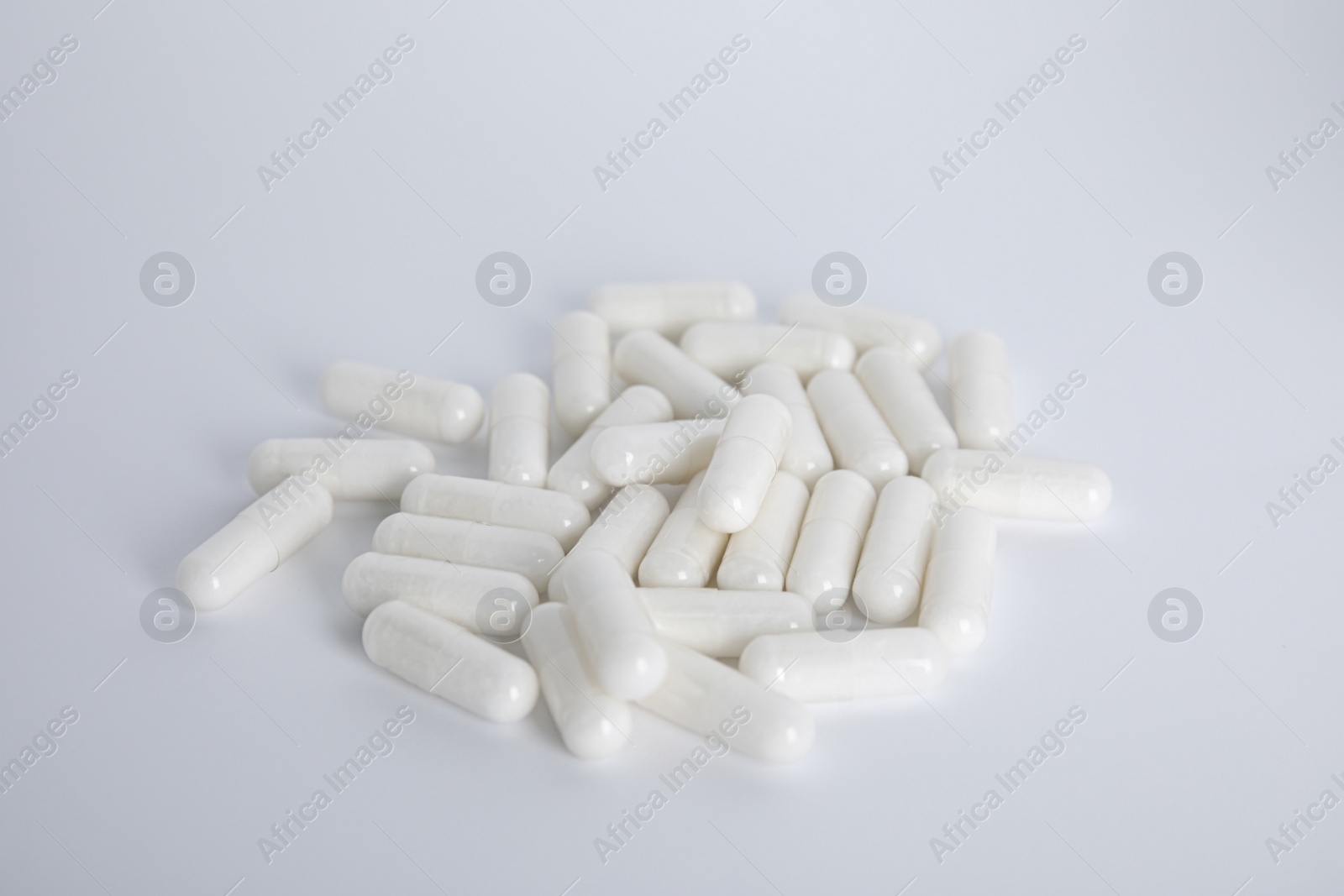 Photo of Pile of amino acid pills on white background