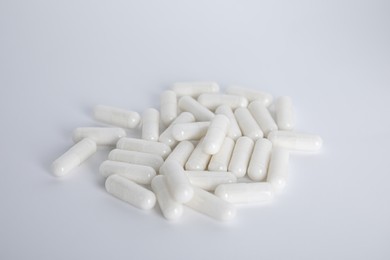 Photo of Pile of amino acid pills on white background