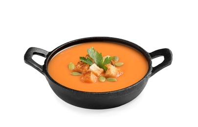 Photo of Tasty creamy pumpkin soup with croutons, seeds and parsley in bowl on white background