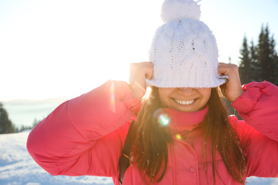 Young woman having fun outdoors on snowy winter day