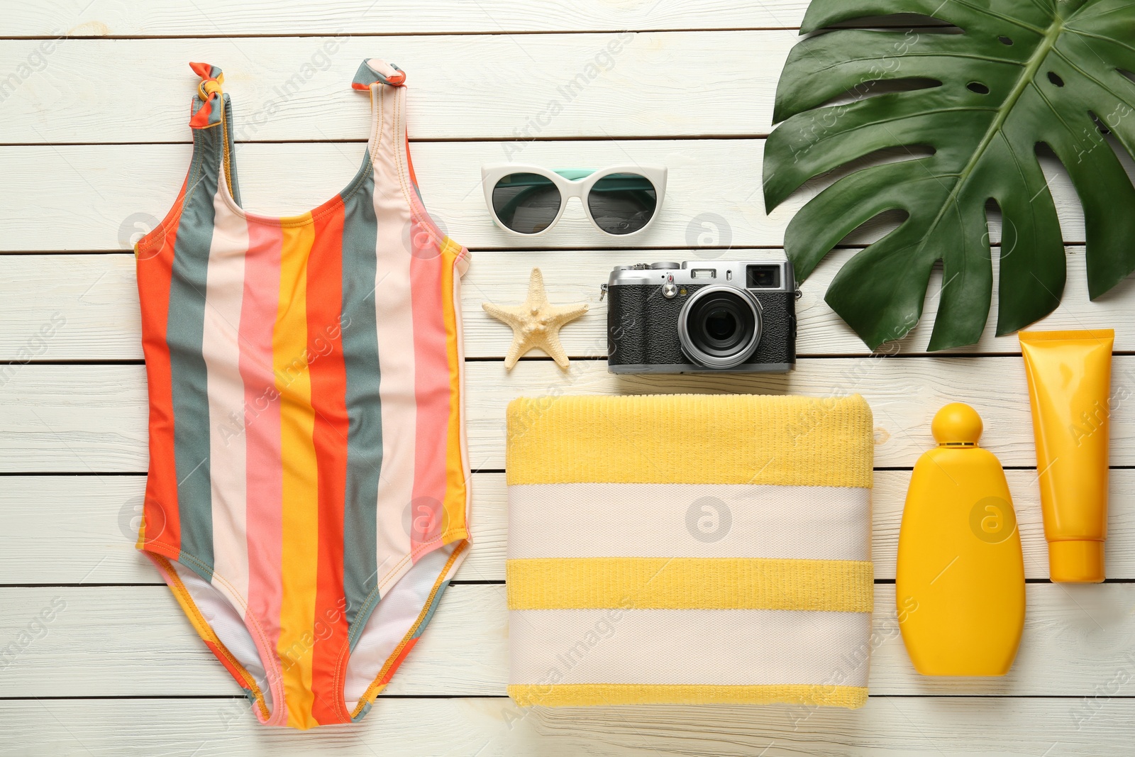 Photo of Flat lay composition with beach objects on white wooden background