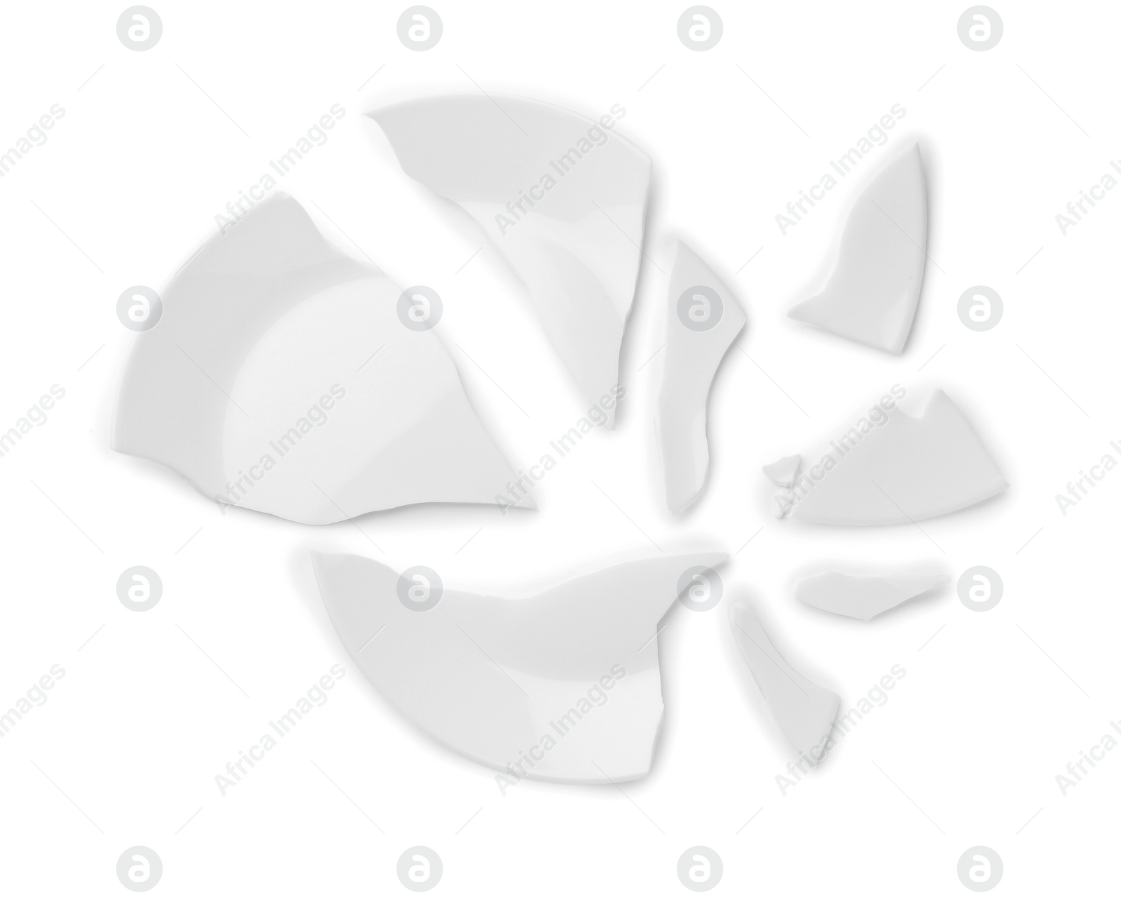 Photo of Pieces of broken ceramic plate on white background, top view