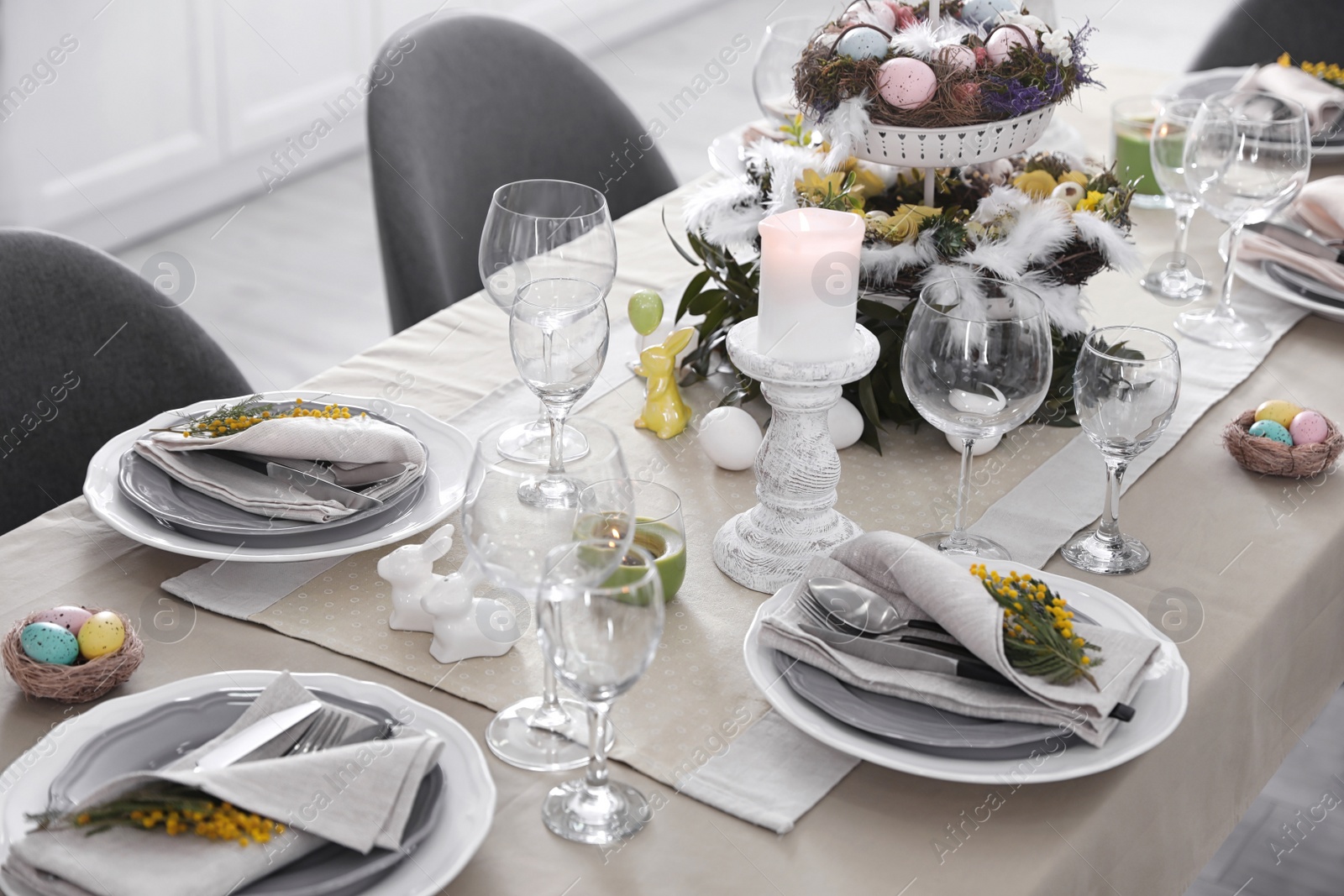 Photo of Beautiful Easter table setting with floral decor indoors