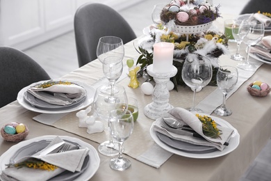 Beautiful Easter table setting with floral decor indoors