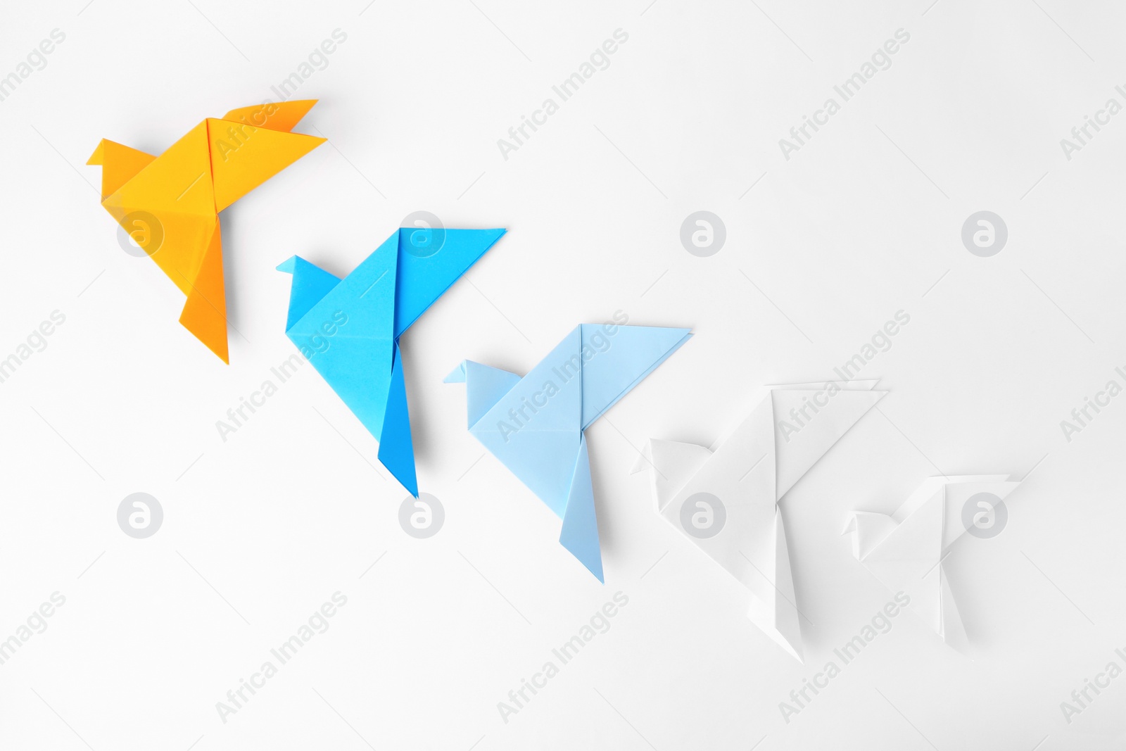 Photo of Colorful handmade paper birds on white background, flat lay