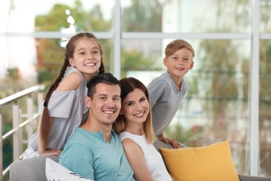 Photo of Happy family with cute children at home