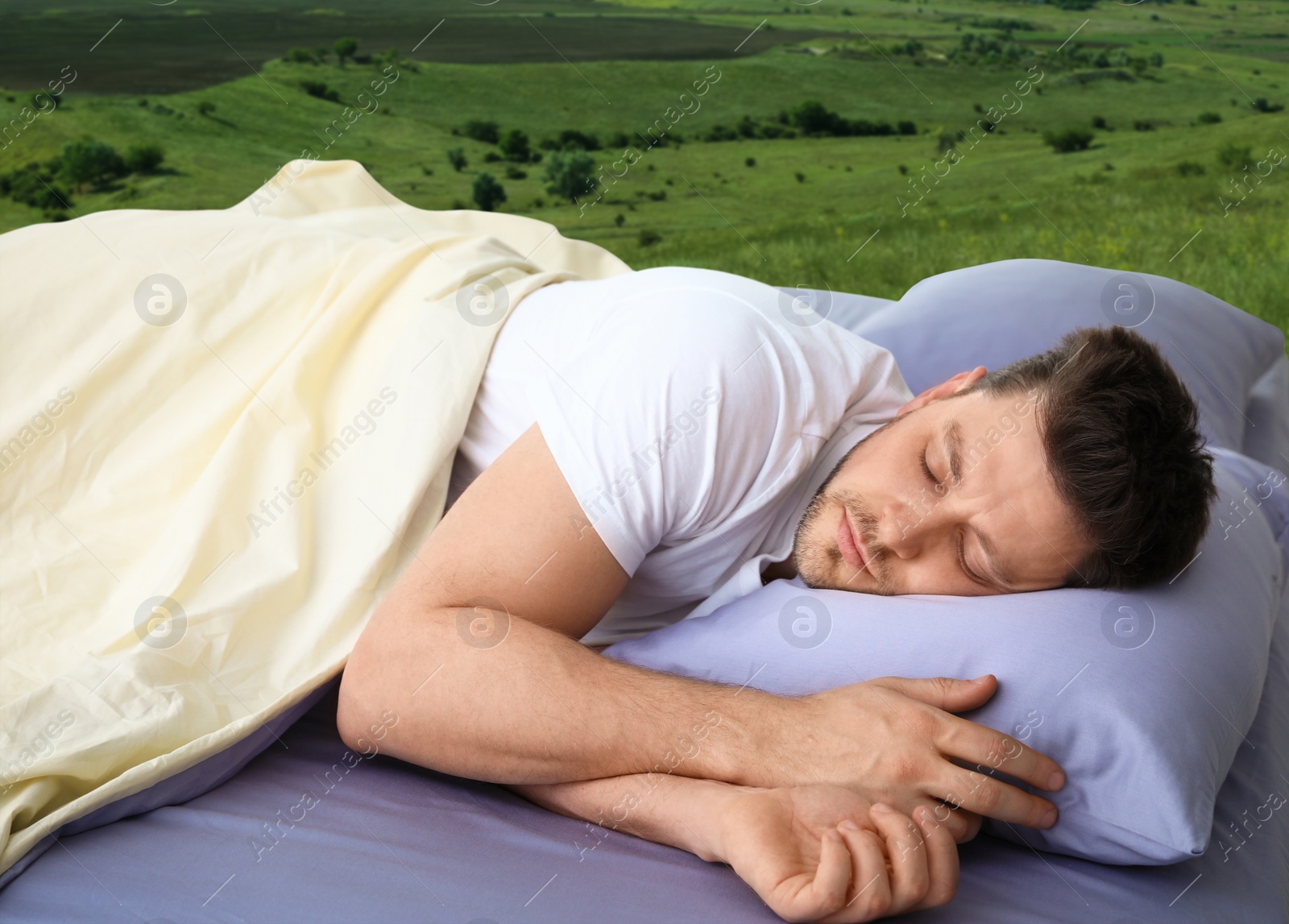 Image of Man sleeping in bed and beautiful view of green lawn on background. Sleep well - stay healthy