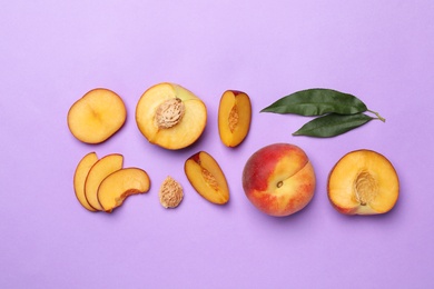 Photo of Flat lay composition with sweet juicy peaches on lilac background