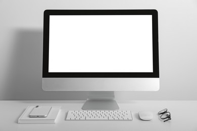 Photo of Workplace with modern computer and smartphone on white table. Mockup for design