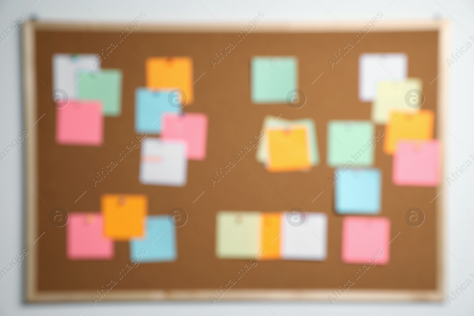 Photo of Blurred view of cork board with many colorful notes