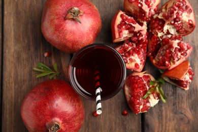 Pomegranate juice and fresh fruits on wooden table, flat lay