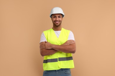 Photo of Engineer in hard hat on beige background