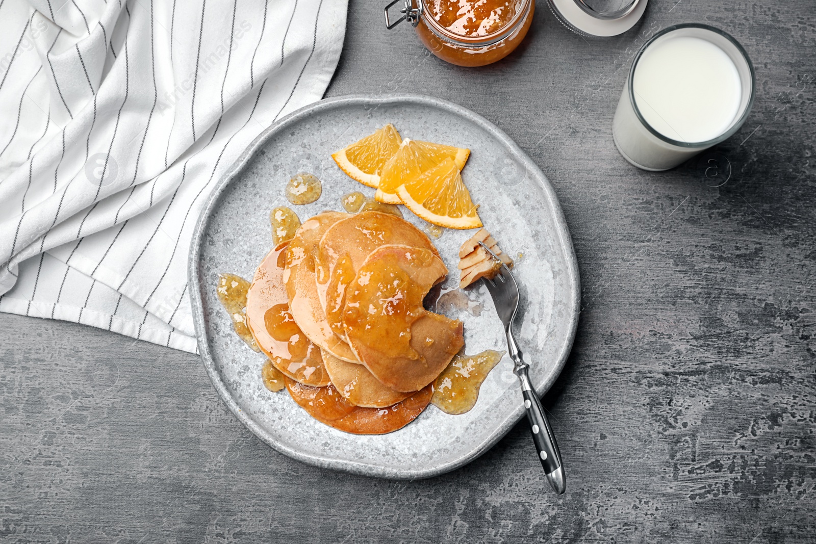 Photo of Plate with delicious pancakes on table