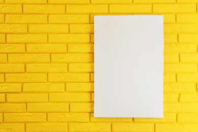 Blank canvas on yellow brick wall. Space for design