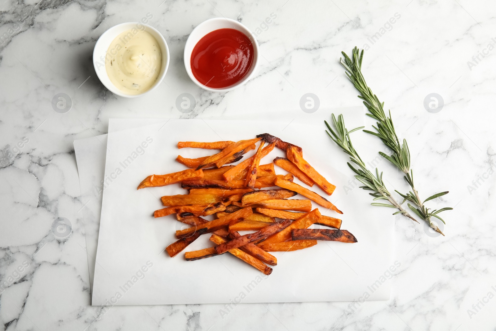 Photo of Flat lay composition with baked sweet potato slices on marble background