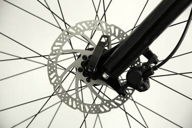 Photo of Bicycle wheel on light background, closeup view