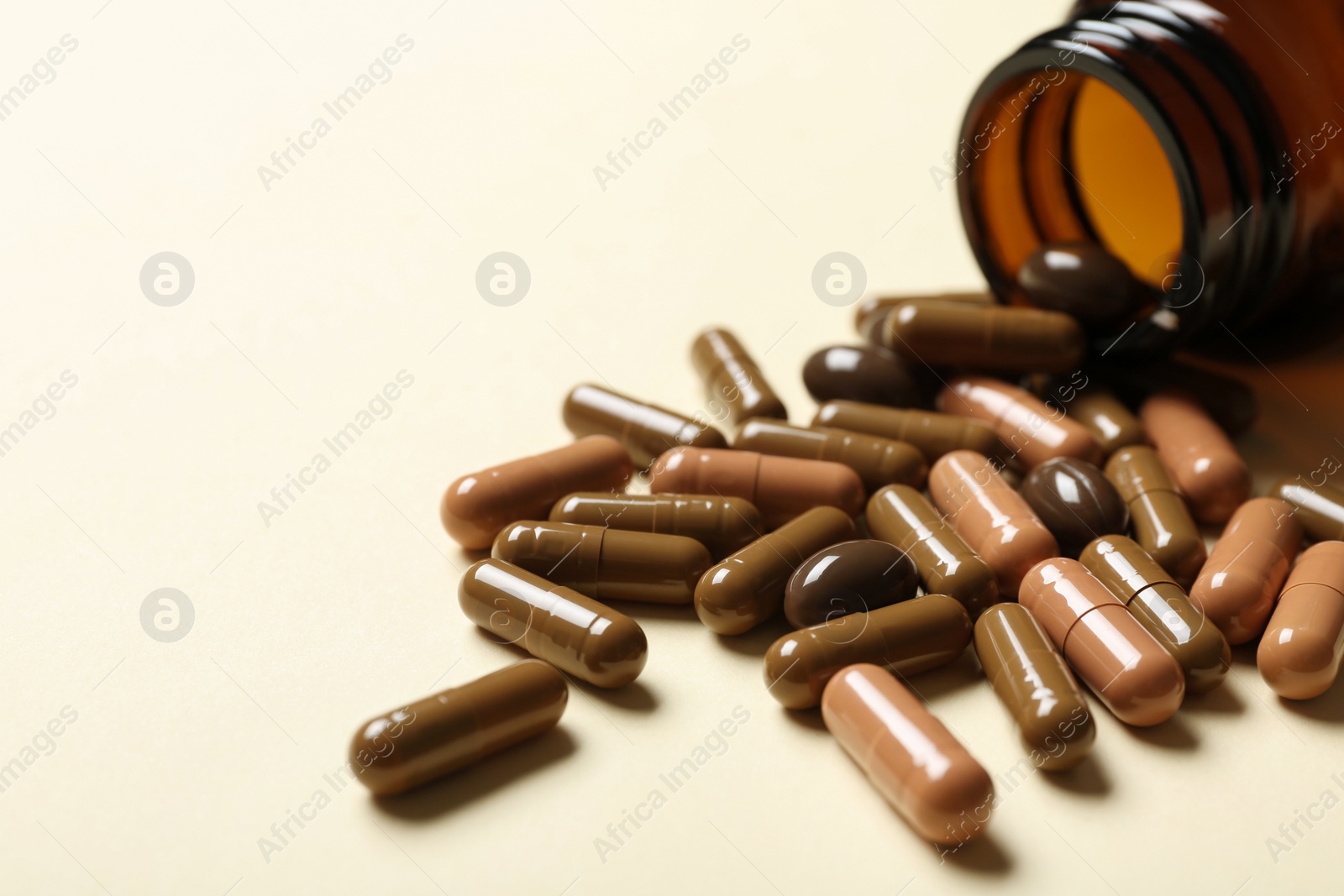 Photo of Bottle with vitamin capsules on color background, closeup. Space for text