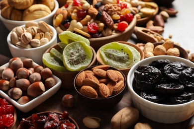 Composition of different dried fruits and nuts on table, closeup