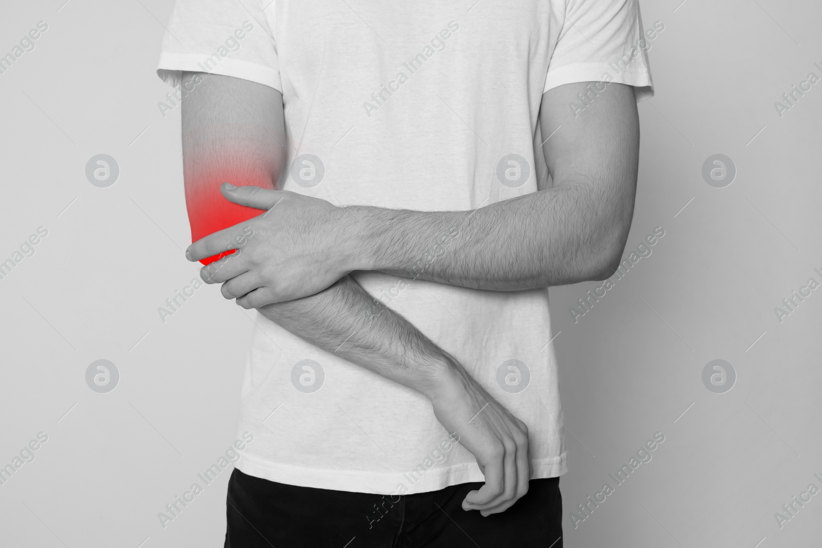 Image of Man suffering from pain in elbow, closeup. Black and white effect