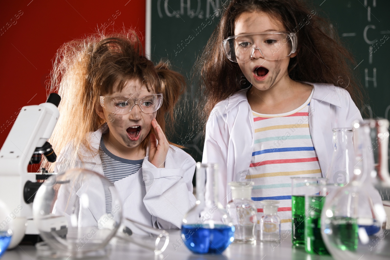 Photo of Children doing chemical research in laboratory. Dangerous experiment