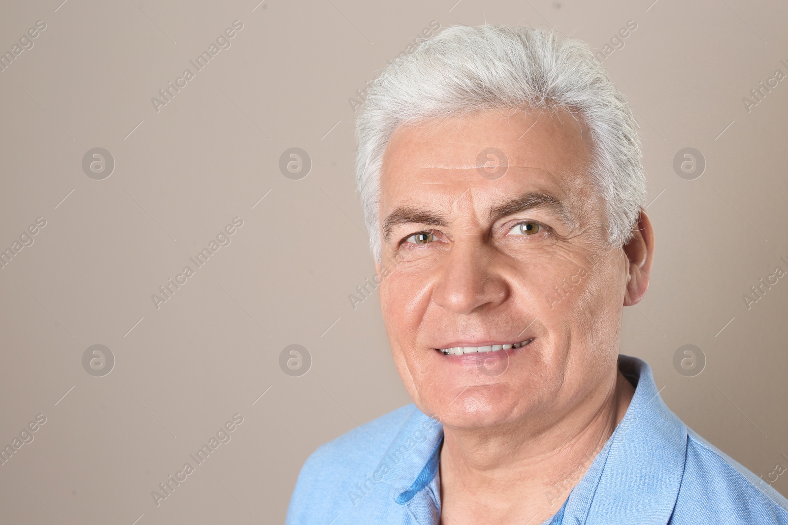 Photo of Mature man with healthy teeth on color background. Space for text