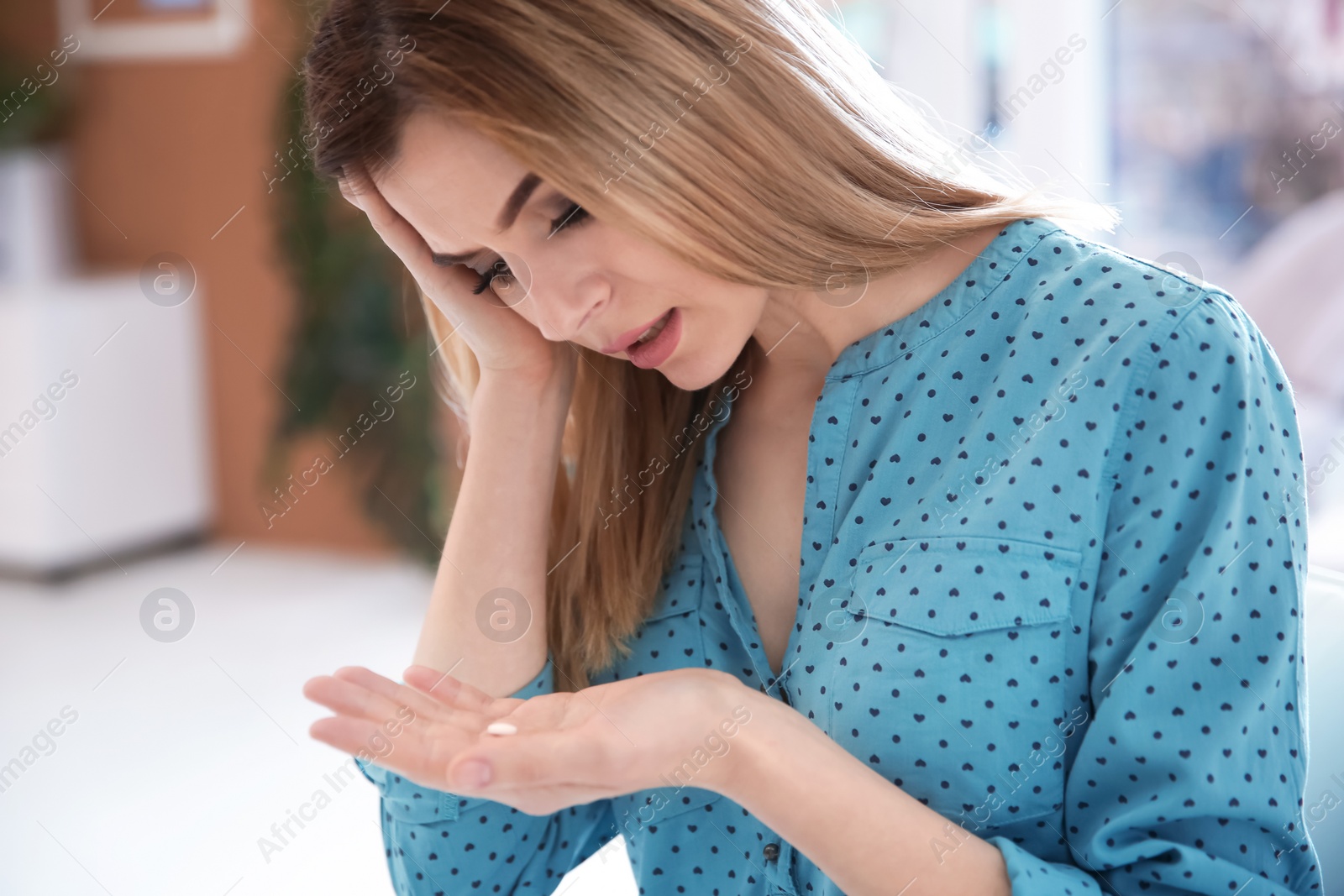 Photo of Young woman with pill indoors