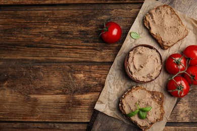 Photo of Fresh bread with delicious meat pate, cherry tomatoes and basil on wooden table, flat lay. Space for text