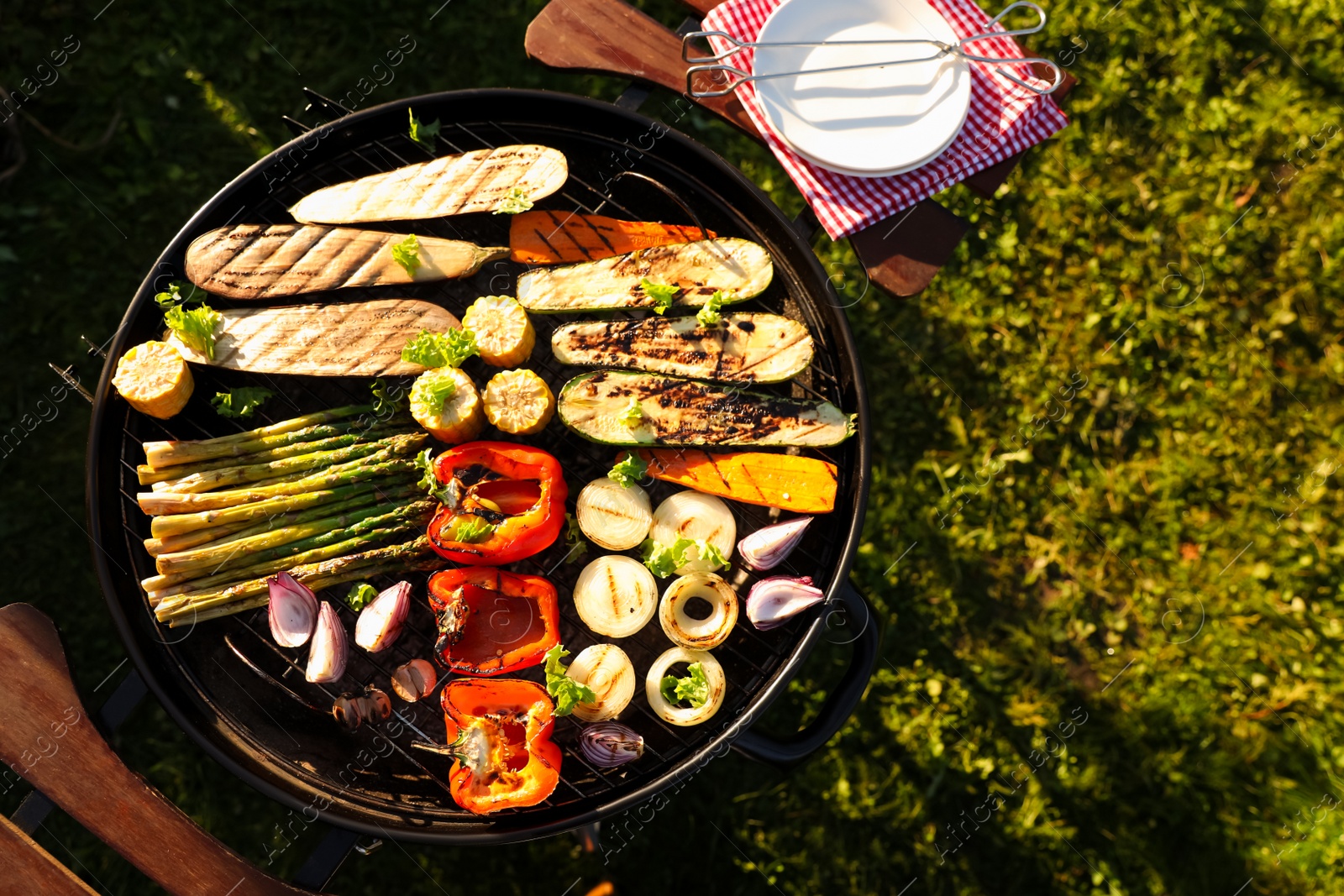 Photo of Delicious grilled vegetables on barbecue grill outdoors, top view. Space for text