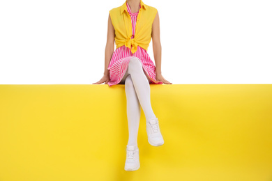 Photo of Woman wearing white tights sitting on color background, closeup