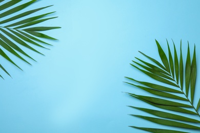 Photo of Flat lay composition with tropical areca palm leaves and space for text on color background