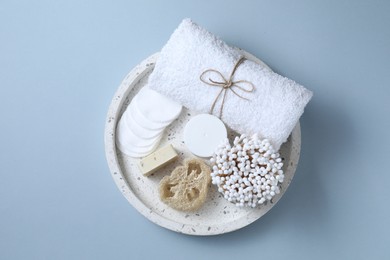 Photo of Bath accessories. Personal care products on light blue background, top view