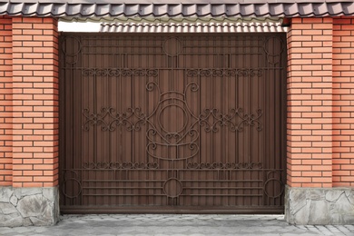 Photo of Metal gates with forged elements in modern cottage